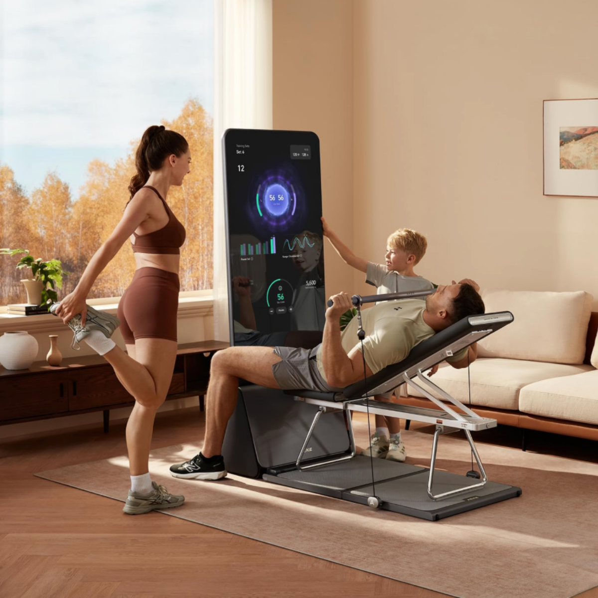 Family using the gray and black AEKE Fitness Mirror K1 smart home gym system in a modern living room, showcasing versatile home fitness and personalized training programs.