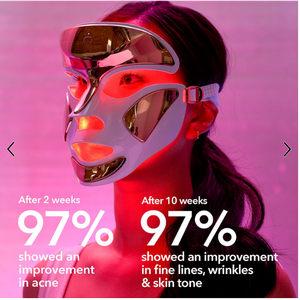Woman wearing Dr. Dennis Gross SpectraLite FaceWare Pro LED face mask during red light therapy treatment for acne and anti-aging skincare.