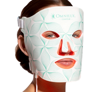 Woman wearing the Omnilux Contour Face LED mask during a red light and near-infrared light therapy facial treatment.