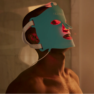 A man wearing the HigherDOSE Red Light Face Mask during a red light therapy treatment designed to support collagen production and healthier-looking skin.