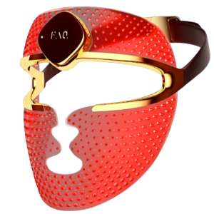 An angled profile shot of the pink Foreo FAQ 202 Plus wireless silicone LED face mask, highlighting its flexible form-fitting contour, gold metallic trim around the eye visor, and adjustable black straps for zero-gap clinical red light therapy