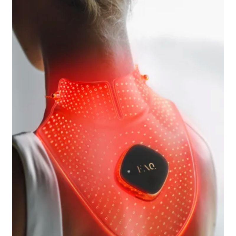 A rear view of a woman wearing the Foreo FAQ 211 translucent silicone light therapy mask glowing vibrant red across her neck and upper back, showcasing the form-fitting wrap design, dense inner grid of light points, and central black control module