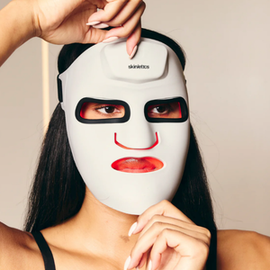 Woman wearing the Skinletics Light Therapy Pro Face Mask during an LED light therapy treatment for skin rejuvenation and wellness support.