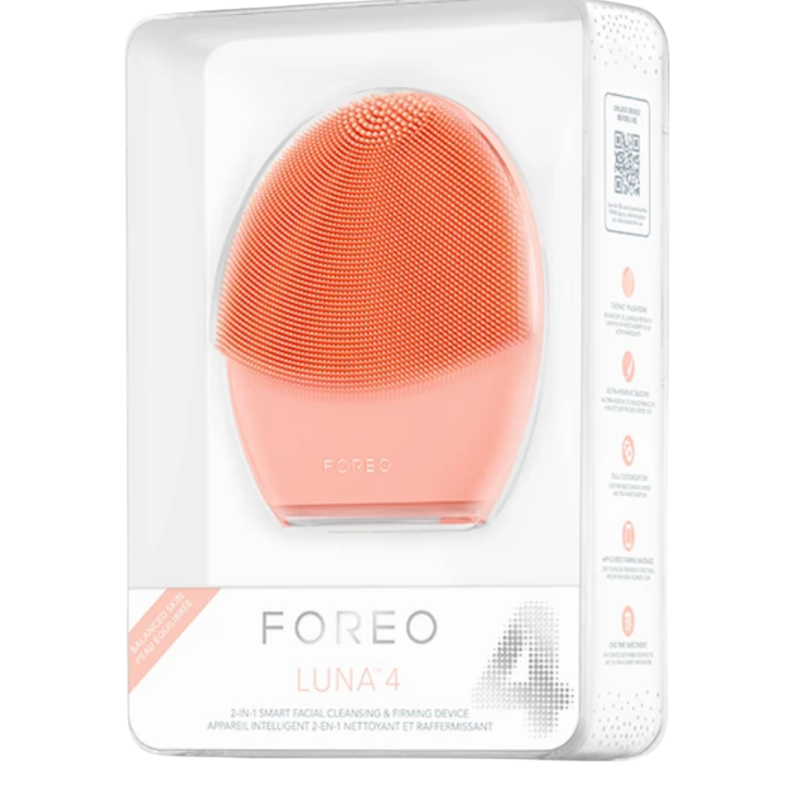 FOREO LUNA 4 smart facial cleansing brush in Peach Perfect for balanced skin types, shown inside its clear-front retail packaging.
