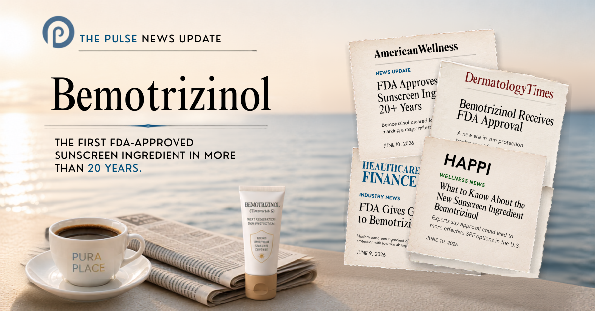 A breaking news post header image by Pura Place announcing FDA approval of the new sunscreen ingredient Bemotrizinol (BEMT). The background features a serene oceanside sunrise with a white coffee cup and a folded newspaper on a table. In the center sits a white tube of sunscreen labeled Bemotrizinol next to a collage of newspaper clippings from American Wellness, Dermatology Times, Healthcare Finance, and HAPPI detailing the historic 2026 U.S. sunscreen monograph expansion.