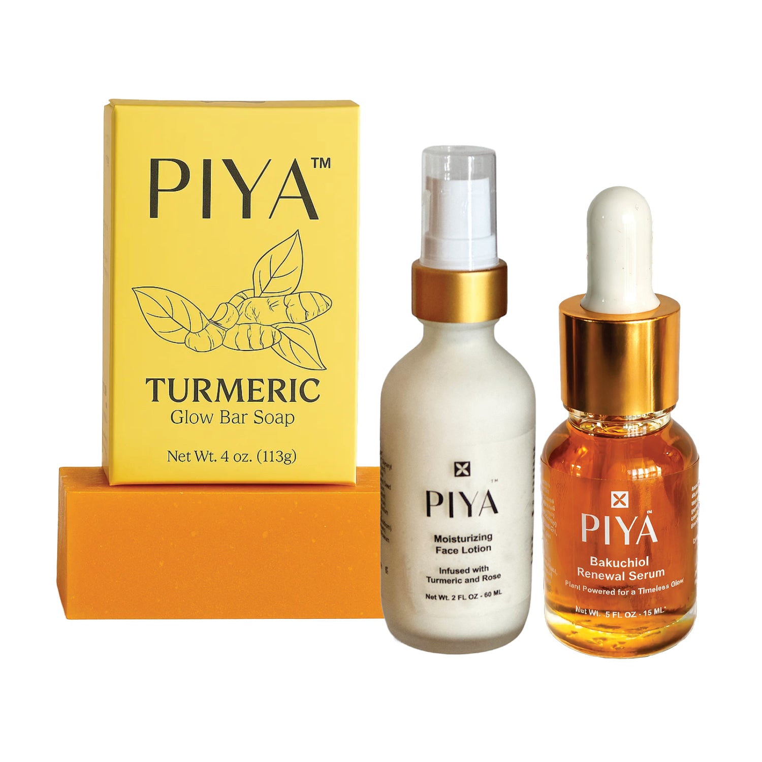 PIYA Beauty Glow Turmeric Ritual skincare set featuring Turmeric Glow Bar Soap in a yellow box, Moisturizing Face Lotion pump bottle, and Saffron Clarifying Serum dropper bottle.